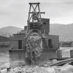 A photograph of a man upon an Araluen Dredge